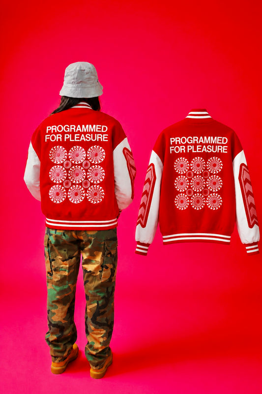 Person wearing a red jacket with 'Programmed for Pleasure' text on a pink background